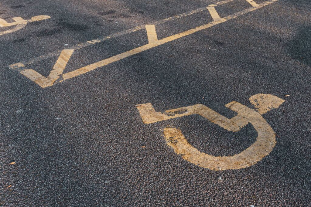 Prominent international wheelchair symbol on asphalt, illustrating accessibility.